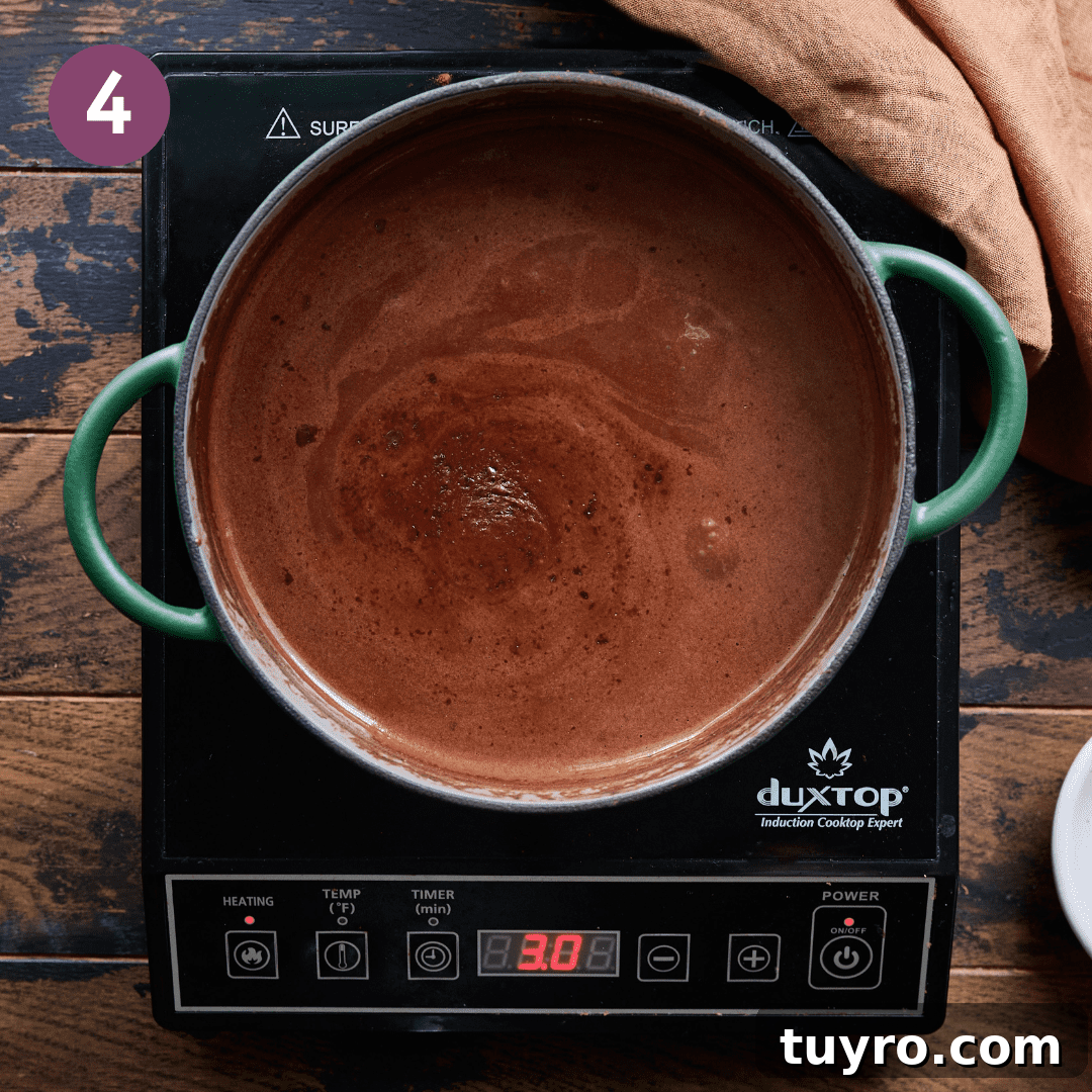Creamy Vegan Hot Chocolate Recipe 9 Creamy hot chocolate mixture in pot.