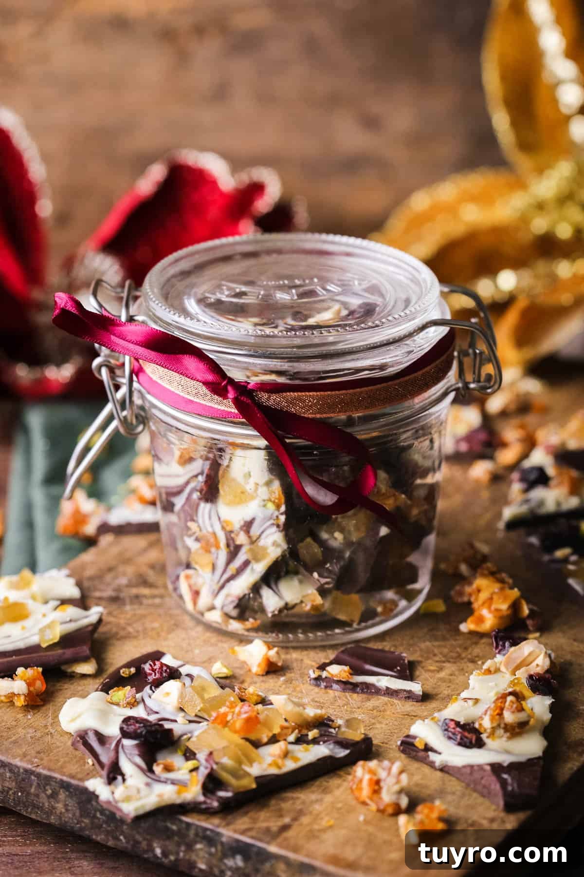 Christmas Chocolate Bark Recipe with Festive Toppings 13 Christmas Chocolate Bark in a jar wrapped with festive ribbon.