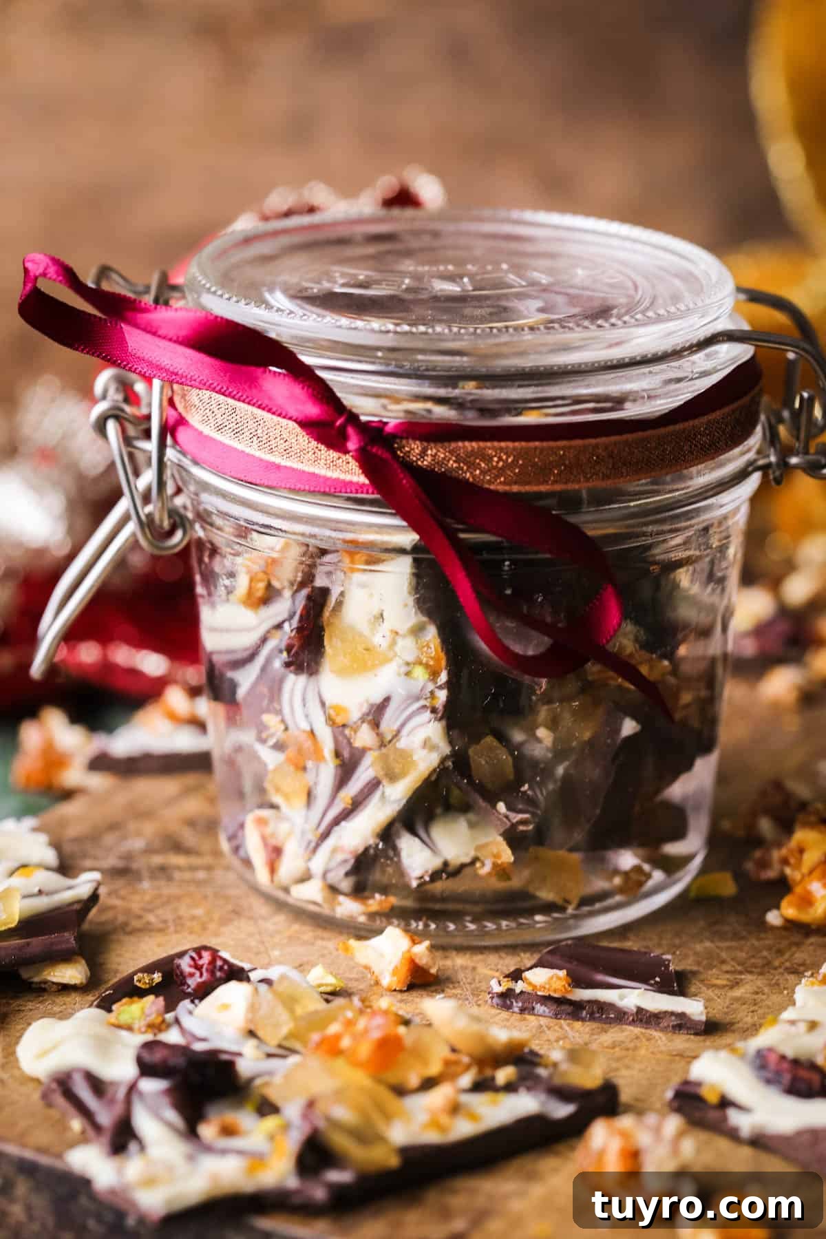 Christmas Chocolate Bark Recipe with Festive Toppings 3 Christmas Chocolate Bark in a jar wrapped with festive ribbon.