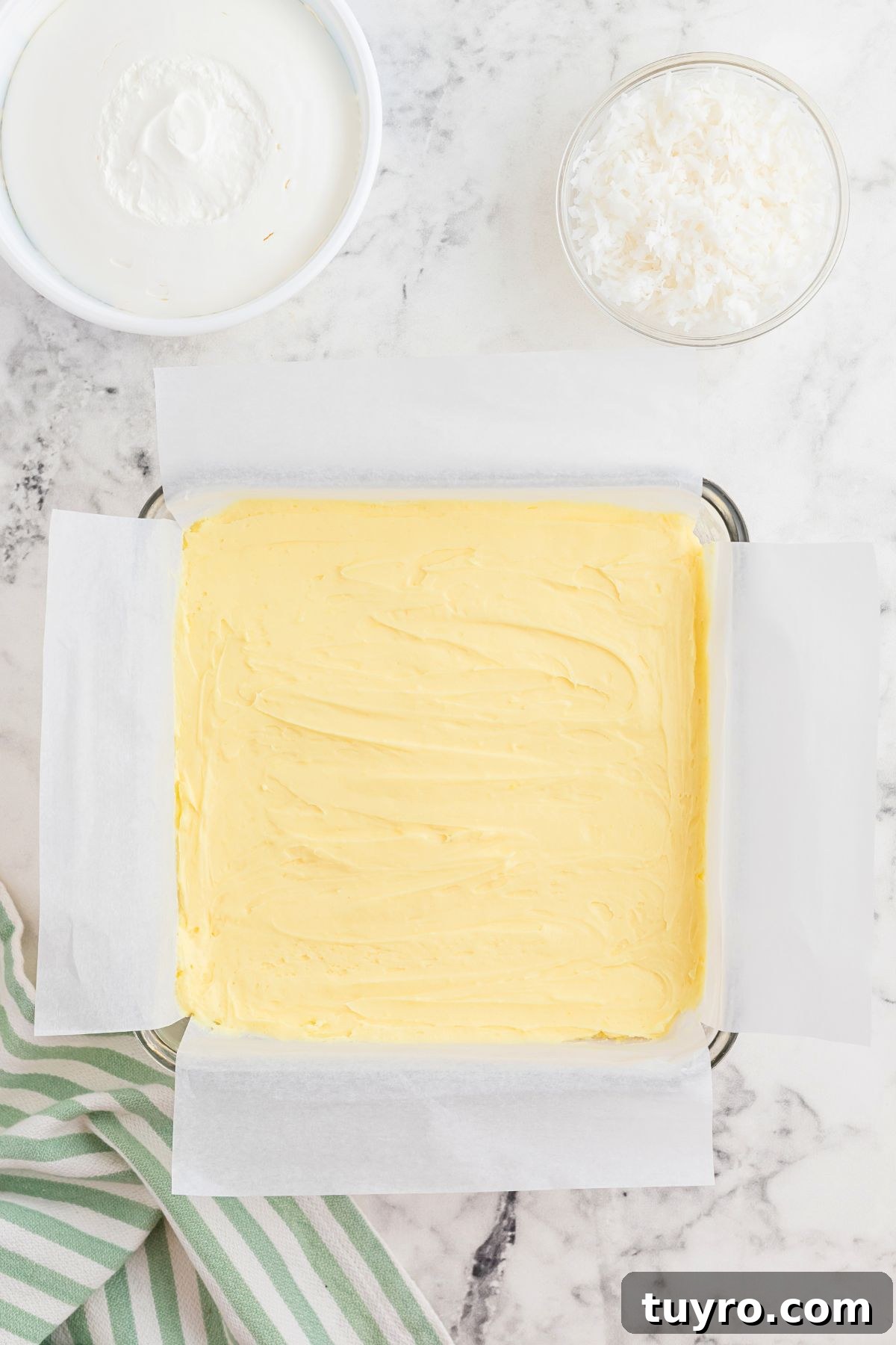 Coconut Delight: Creamy Coconut Dessert Recipe for Home Bakers 6 Cream cheese cheesecake mixture spread over graham cracker crust.