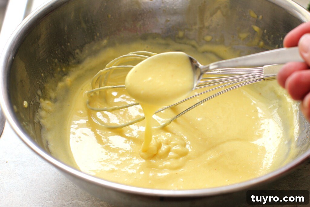 Classic Hollandaise Sauce Recipe for White Asparagus 9 Drizzling a spoonful of Hollandaise to check its thickness.