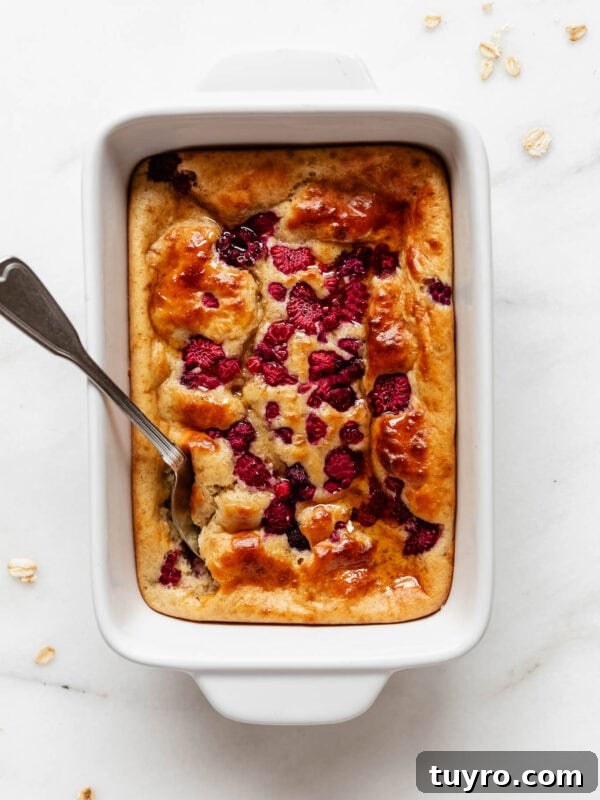 High-Protein Banana Muffins for Quick Breakfast and Snacks 12 a pancake bowl with raspberries in a white baking dish.