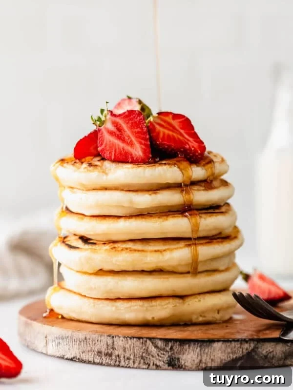 High-Protein Banana Muffins for Quick Breakfast and Snacks 14 a stack of protein pancakes with maple syrup being poured on them