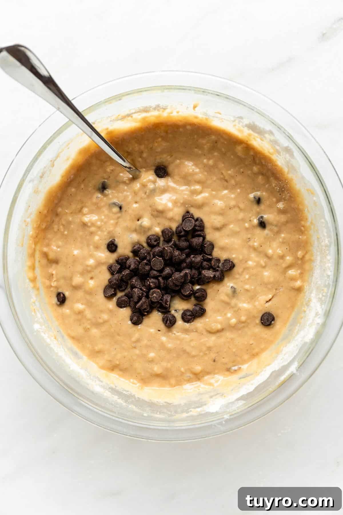 High-Protein Banana Muffins for Quick Breakfast and Snacks 7 Banana muffin batter in a bowl with chocolate chips.