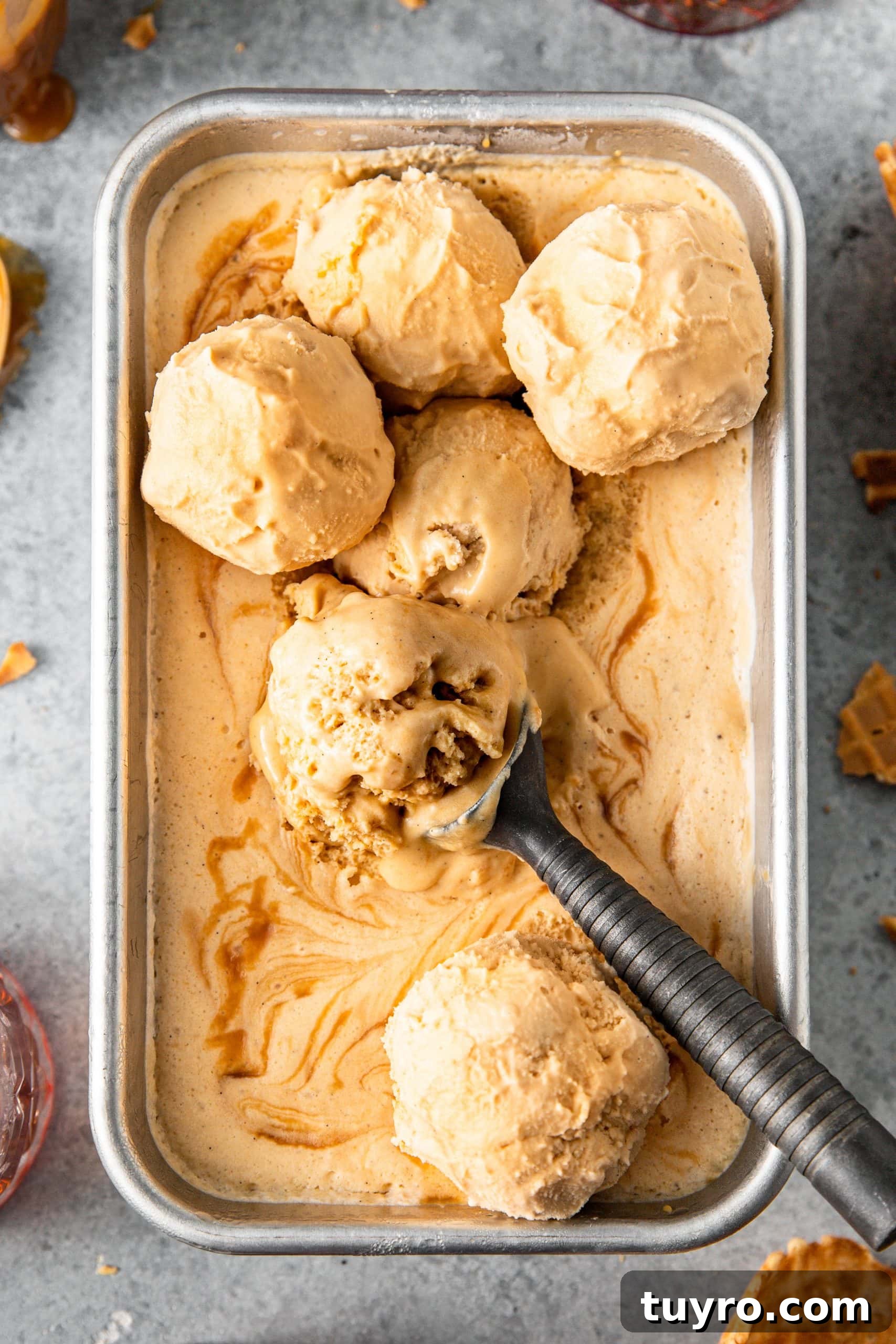 No-Churn Bourbon Salted Caramel Ice Cream Recipe 8 Scoops of No-Churn Bourbon Salted Caramel Ice Cream on top of the ice cream in a loaf pan.