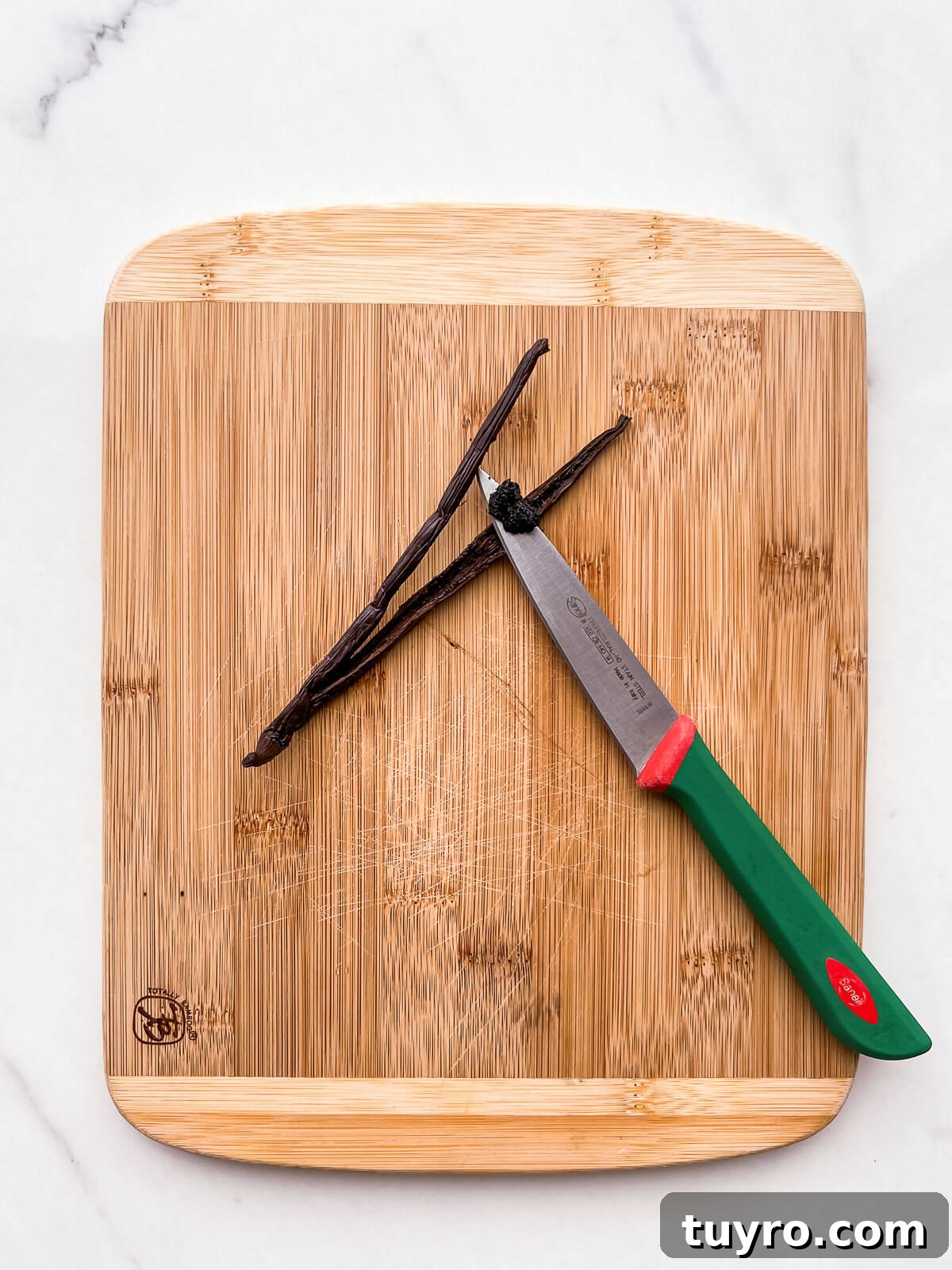 Make Vanilla Sugar at Home: Simple Recipe and Uses 6 Scraping the inside of a split vanilla bean with the back of a pairing knife to remove the black seeds (vanilla caviar).