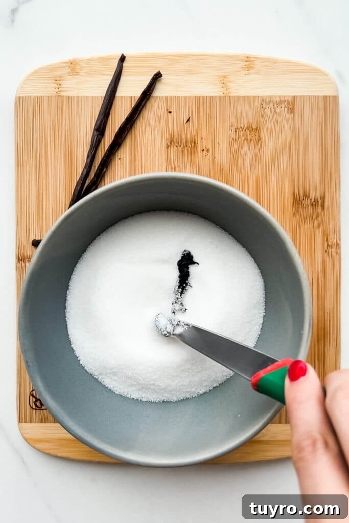 Make Vanilla Sugar at Home: Simple Recipe and Uses 7 Adding vanilla bean seeds to a bowl of sugar to flavour it.