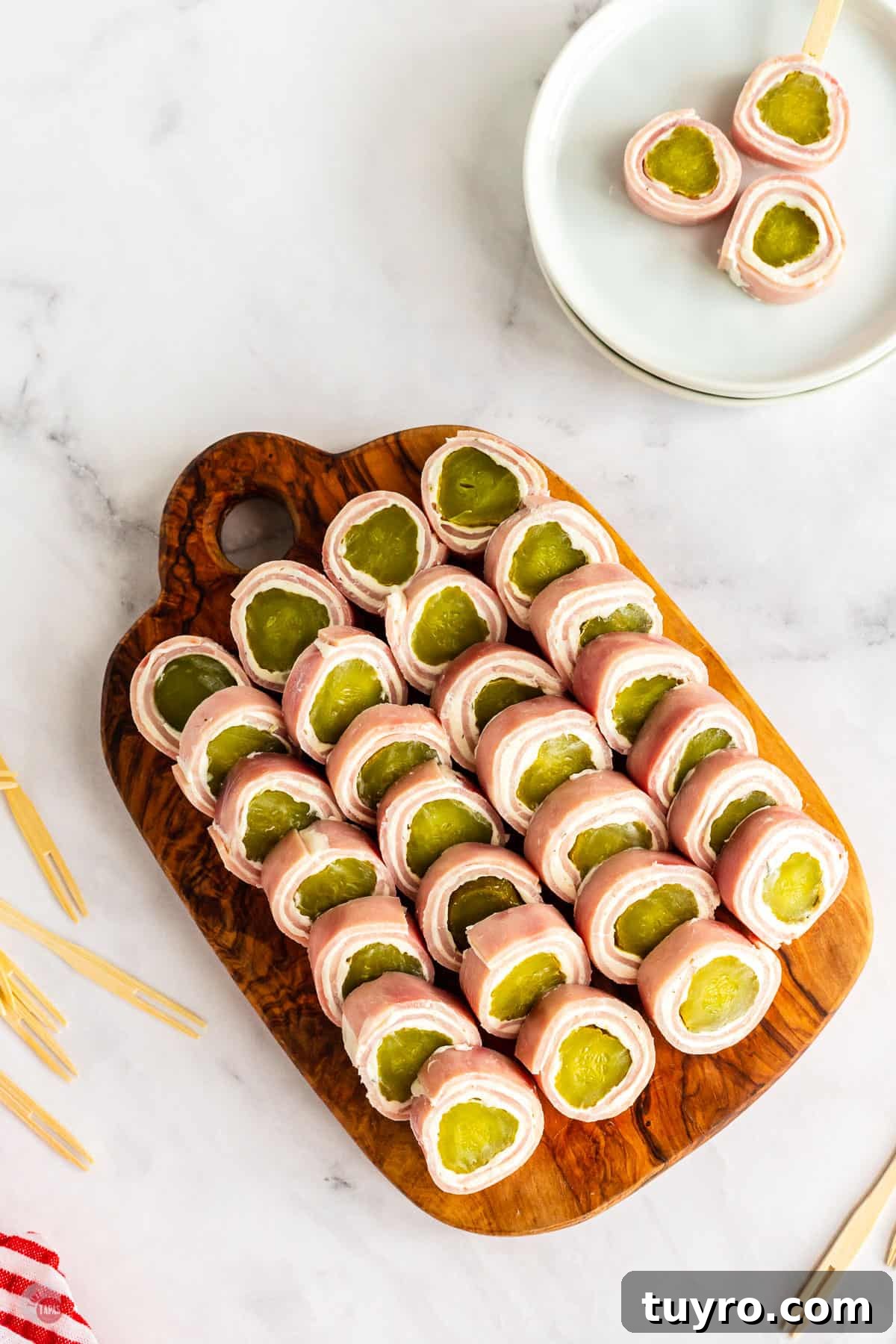 Crunchy Pickle Roll-Ups: Savory Snack Wrap Recipe 10 overhead picture of pickle roll ups on a wood board