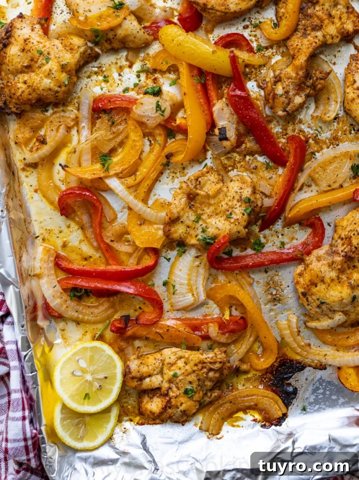 Sheet Pan Italian Chicken with Peppers and Herbs 5 image of a close up of Italian chicken and bell peppers on a sheet pan