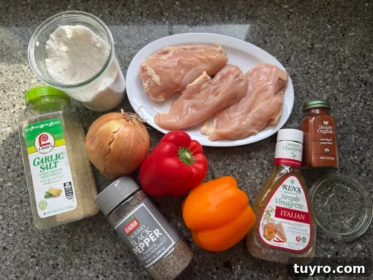 Sheet Pan Italian Chicken with Peppers and Herbs 6 image of sheet pan Italian chicken and peppers (chicken breasts, Italian Dressing, colored bell peppers, onion, black pepper, smoked paprika, salt, and garlic salt)