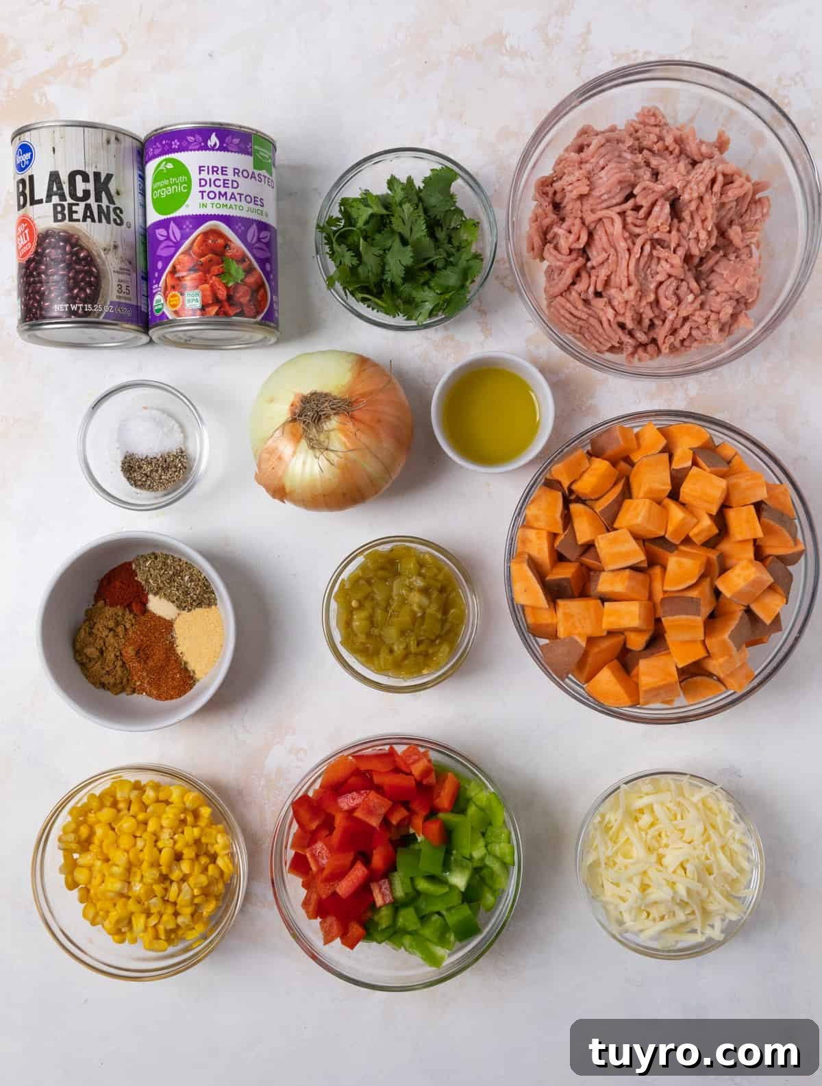 Ground turkey, beans, tomatoes, bell pepper and other recipe ingredients on counter.