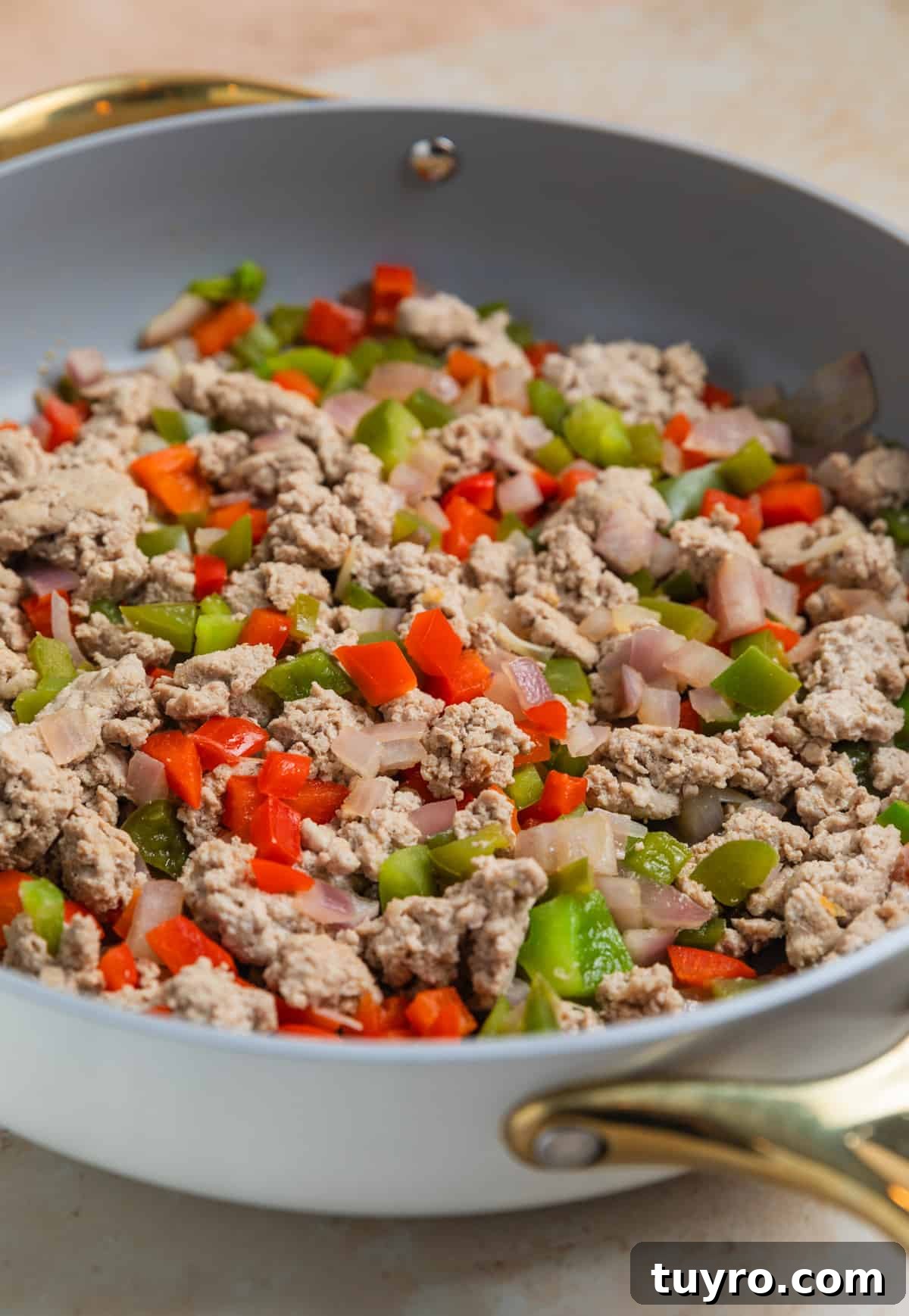 Browned ground turkey and bell peppers in large skillet.