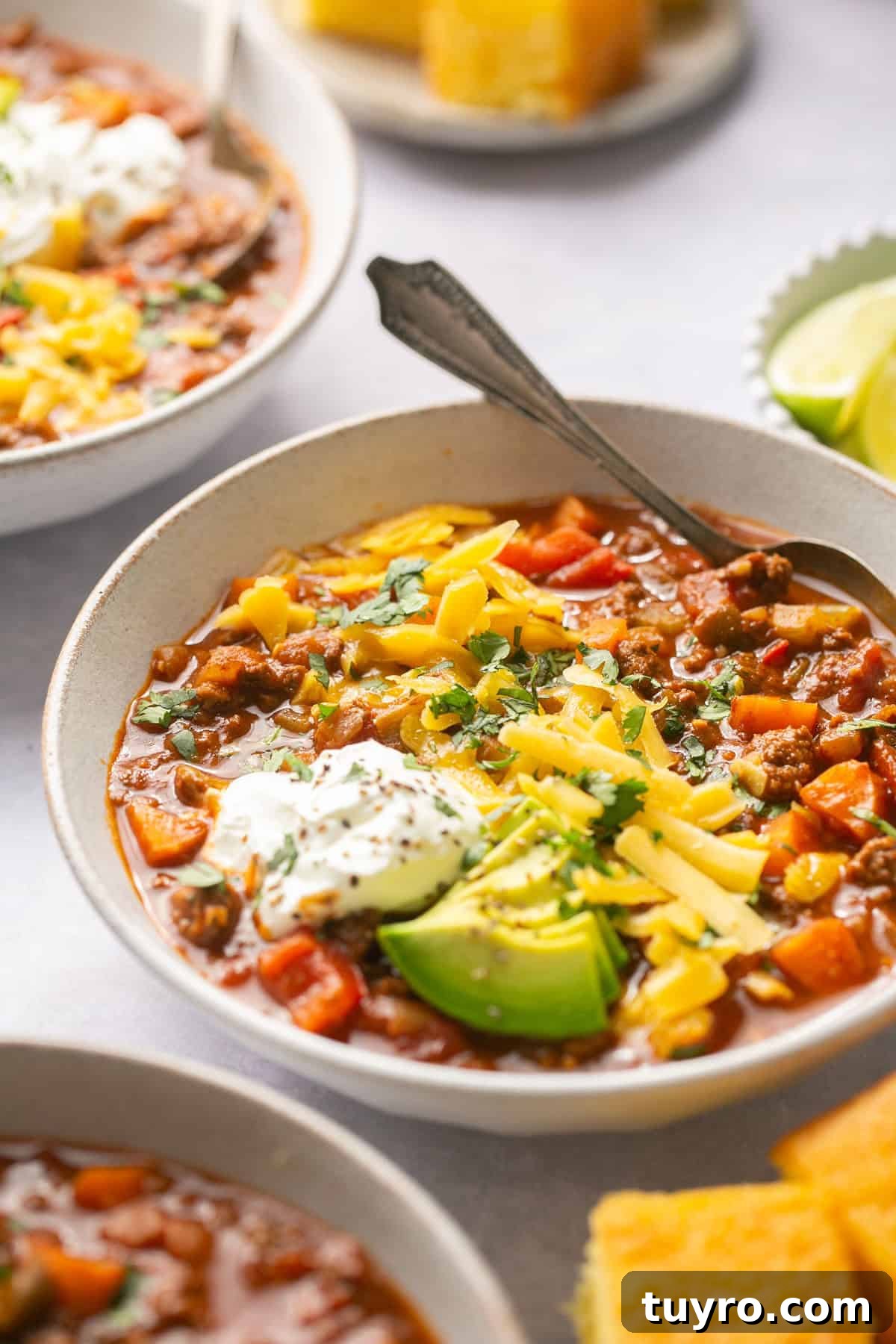 Hearty No-Bean Chili Recipe for Rich, Meaty Flavor 6 a side view of beanless chili in a bowl with toppings