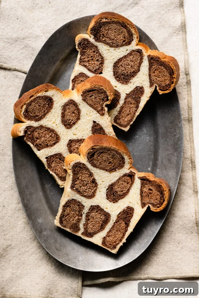 Leopard Milk Bread Recipe: Marbled Hokkaido-Style Loaf 15 Overhead of three slices of leopard print bread on an oval plate.