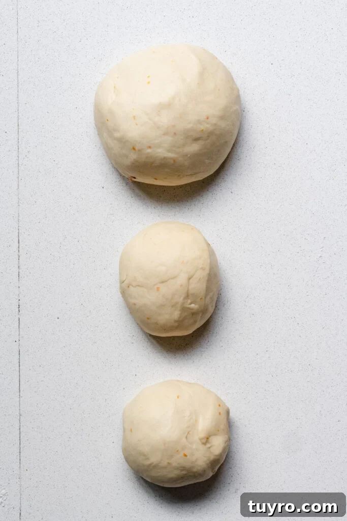 Leopard Milk Bread Recipe: Marbled Hokkaido-Style Loaf 8 Overhead of three balls of dough on a kitchen counter.