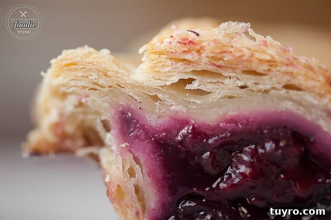 Fresh Summer Berry Pie Recipe 9 A close up of flaky pie crust with berry filling