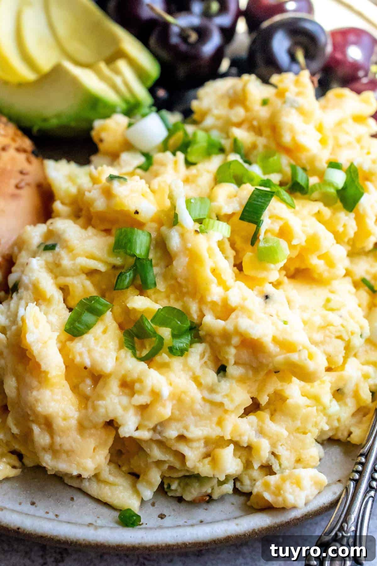 Cottage Cheese with Scrambled Eggs up close on a plate with a fork to the side.