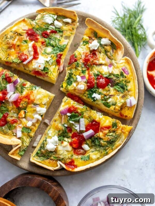 An overhead image of the tortilla quiche bake sliced in four on a serving plate.