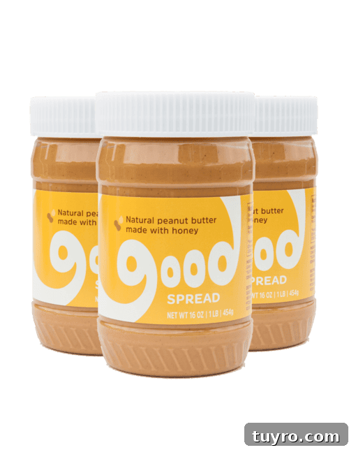 Photo shows three jars of Good Spread natural peanut butter lined up with white lids.