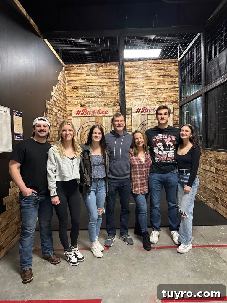 30+ Activities to Connect with Your Young Adult Children 18 Family group smiling together at an axe throwing venue, enjoying a fun and adventurous outing with young adults.