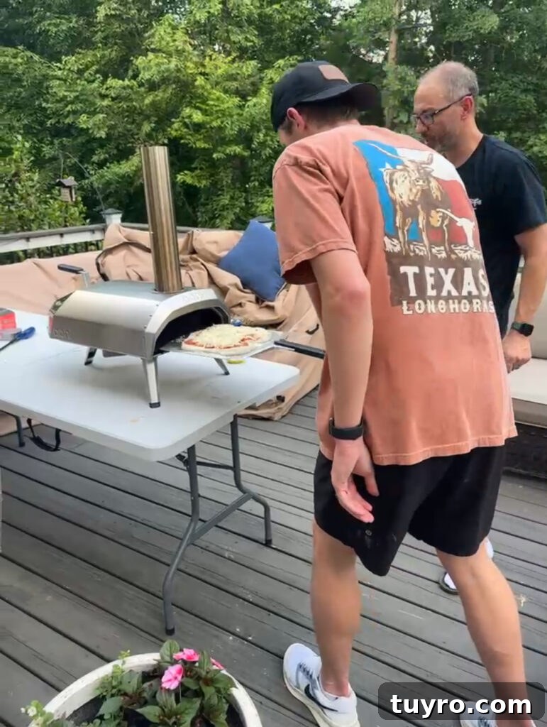 30+ Activities to Connect with Your Young Adult Children 6 Father and son cooking homemade pizza together using an outdoor pizza oven during family pizza night.