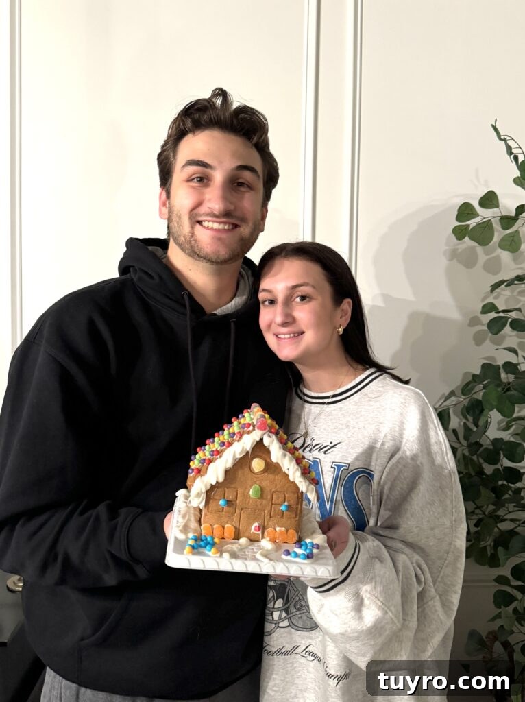 30+ Activities to Connect with Your Young Adult Children 7 Smiling couple holding a decorated gingerbread house covered with colorful candies and icing during a family Thanksgiving contest.