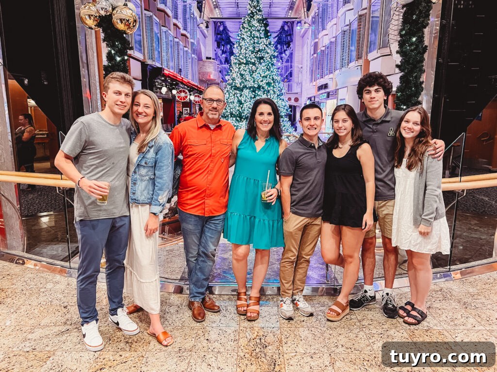30+ Activities to Connect with Your Young Adult Children 10 Family group dressed up on a cruise ship at Christmas, standing in front of a decorated tree and celebrating the holiday together.