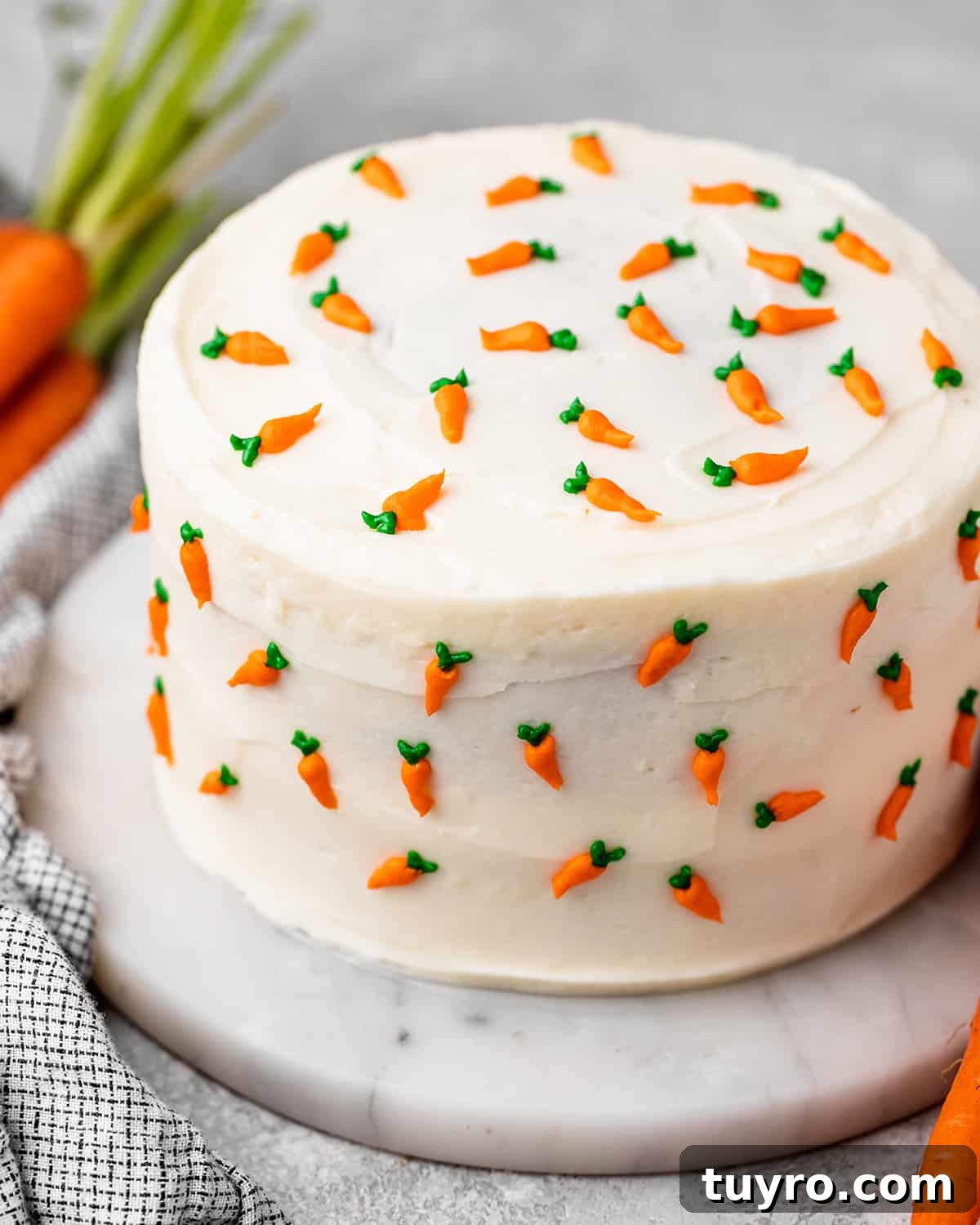 Moist Carrot Cake Recipe with Cream Cheese Frosting 15 a whole carrot cake with cream cheese frosting and tiny frosting carrots all around it