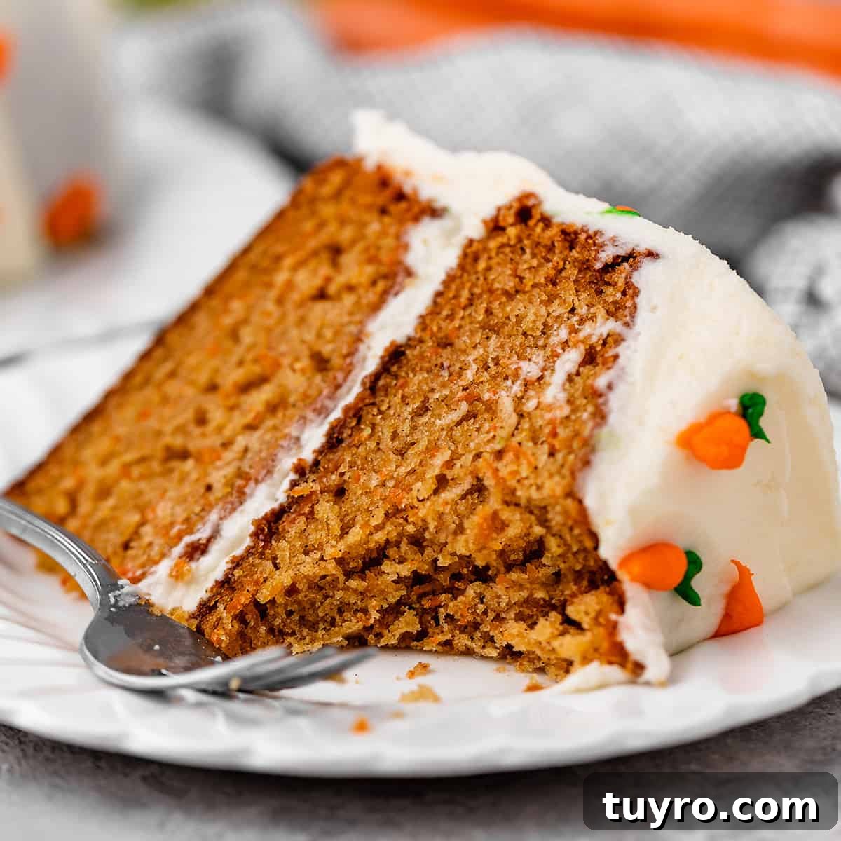 Moist Carrot Cake Recipe with Cream Cheese Frosting 18 a slice of carrot cake with a bite taken out of it