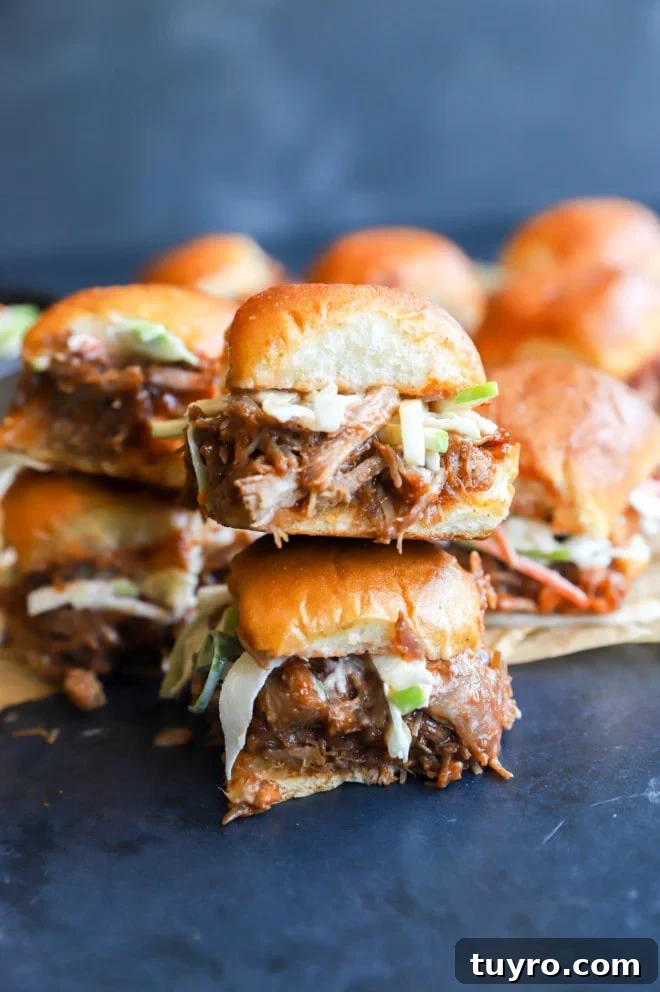 BBQ Pulled Pork Sliders with Crisp Apple Coleslaw 3 Side image of pork sandwiches stacked