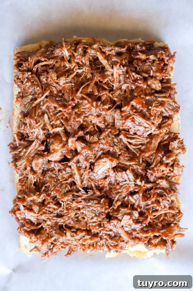 BBQ Pulled Pork Sliders with Crisp Apple Coleslaw 7 Pulled pork on buns on baking sheet image