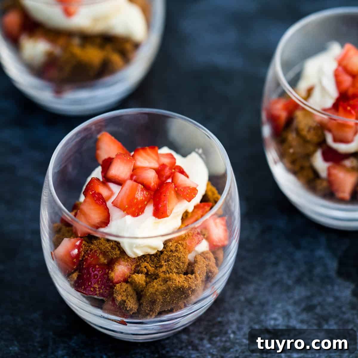 Moist Apple Almond Cake Recipe with Cinnamon 11 strawberry parfait with mascarpone cream in short glass with two other parfaits in the background