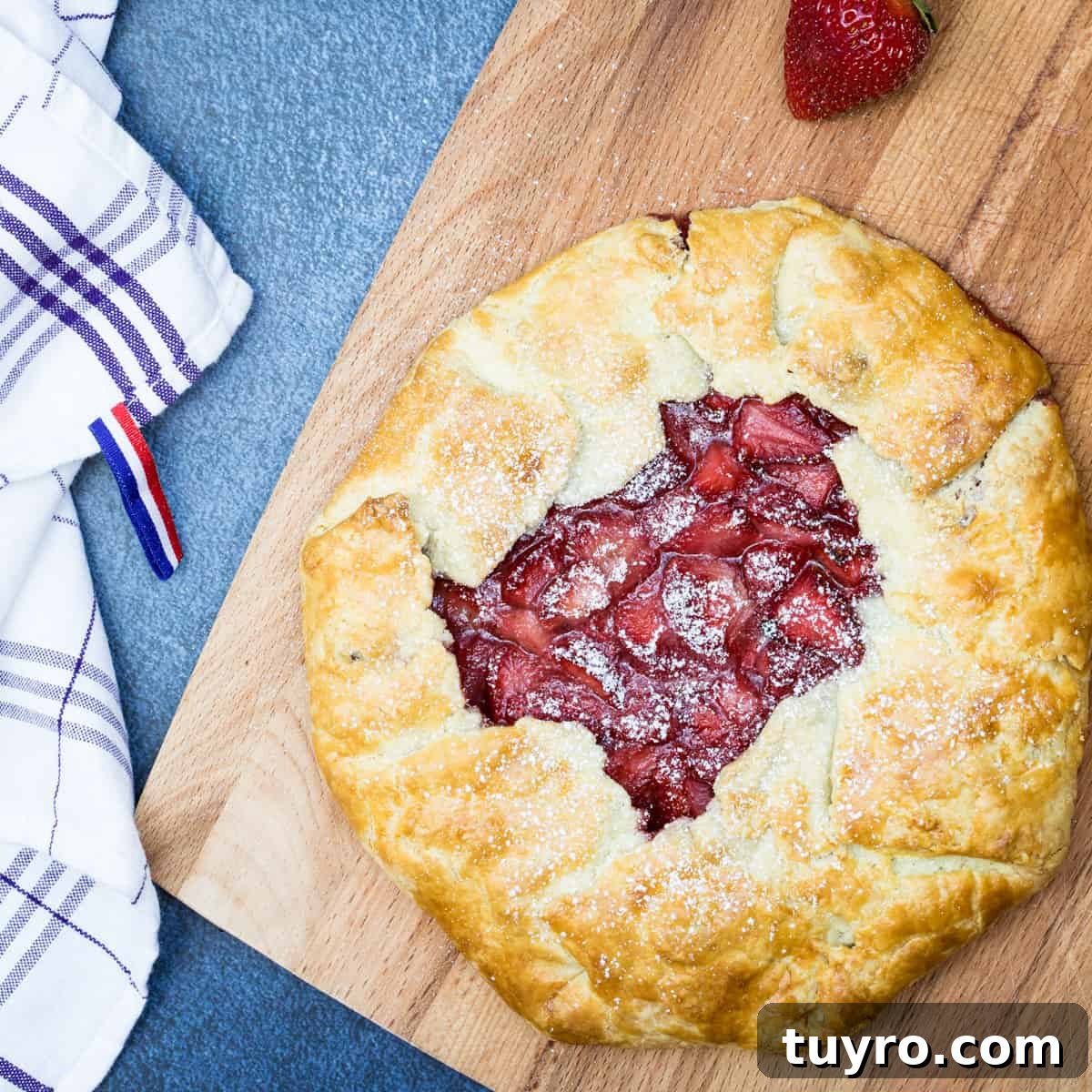 Moist Apple Almond Cake Recipe with Cinnamon 14 strawberry galette on cutting board with kitchen towel
