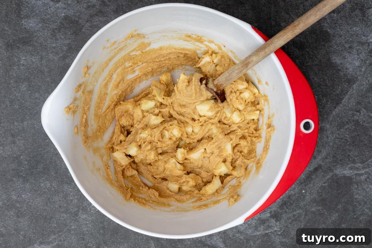 Moist Apple Almond Cake Recipe with Cinnamon 8 batter for apple almond cake in mixing bowl with spoon