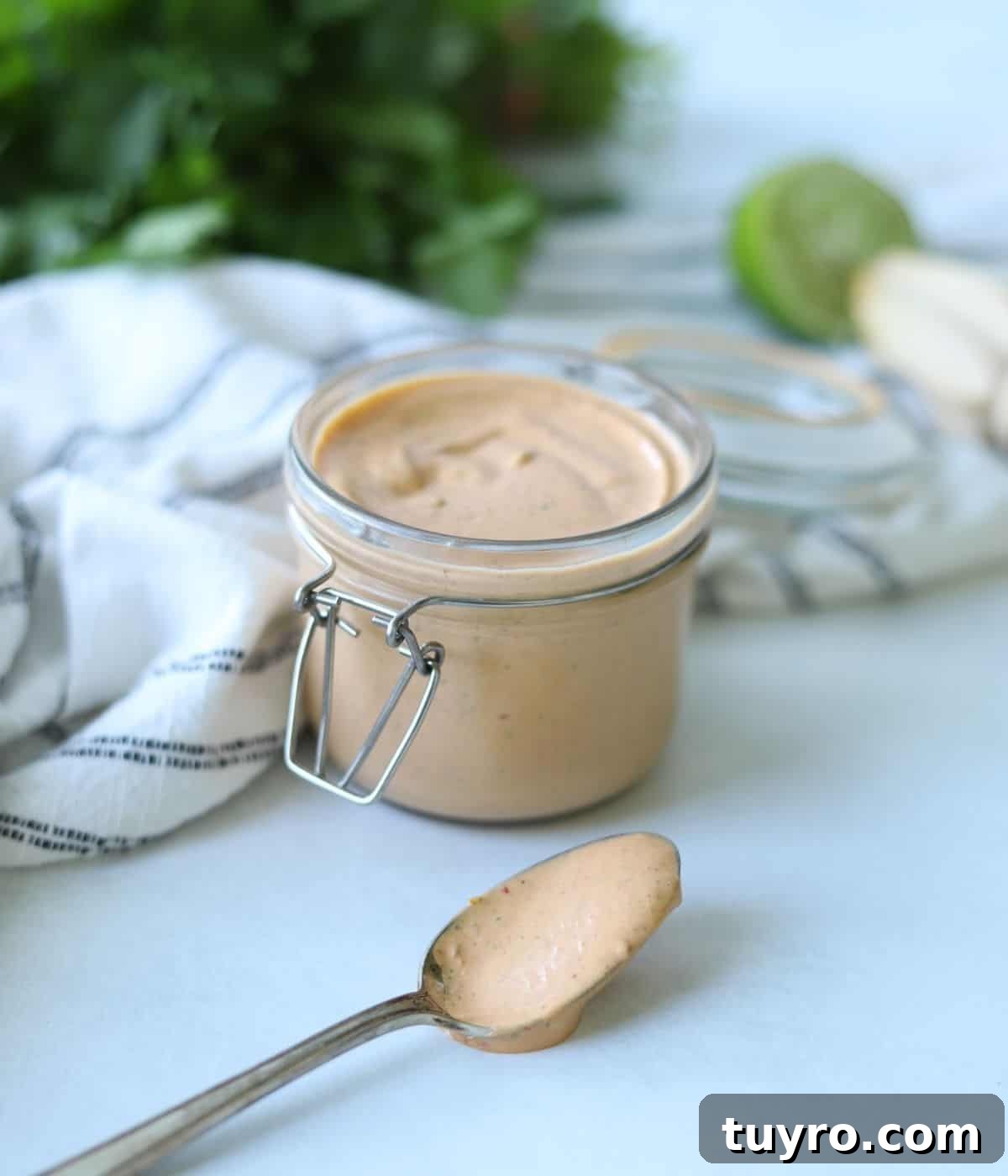 Quick Chipotle Lime Sauce Recipe — Ready in 5 Minutes 2 chipotle mayo in glass container with spoonful sitting in front