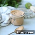 chipotle mayo in glass container with spoonful sitting in front