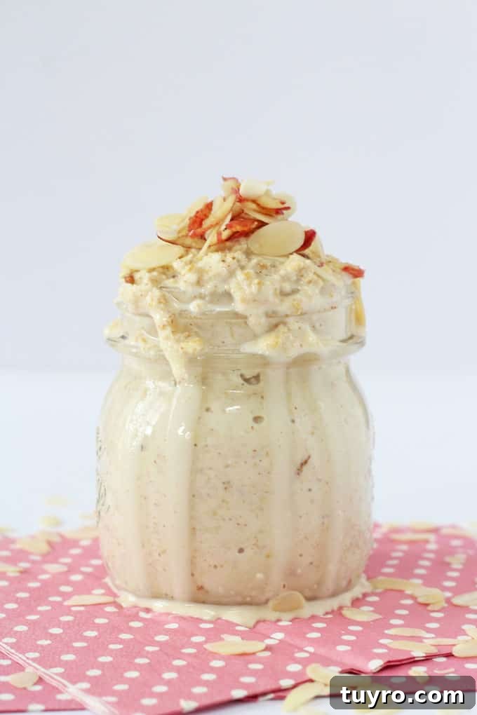 Creamy Apple and Almond Butter Overnight Oats 3 Apple & almond butter overnight oats served in a glass jar, and garnished with flaked almonds.