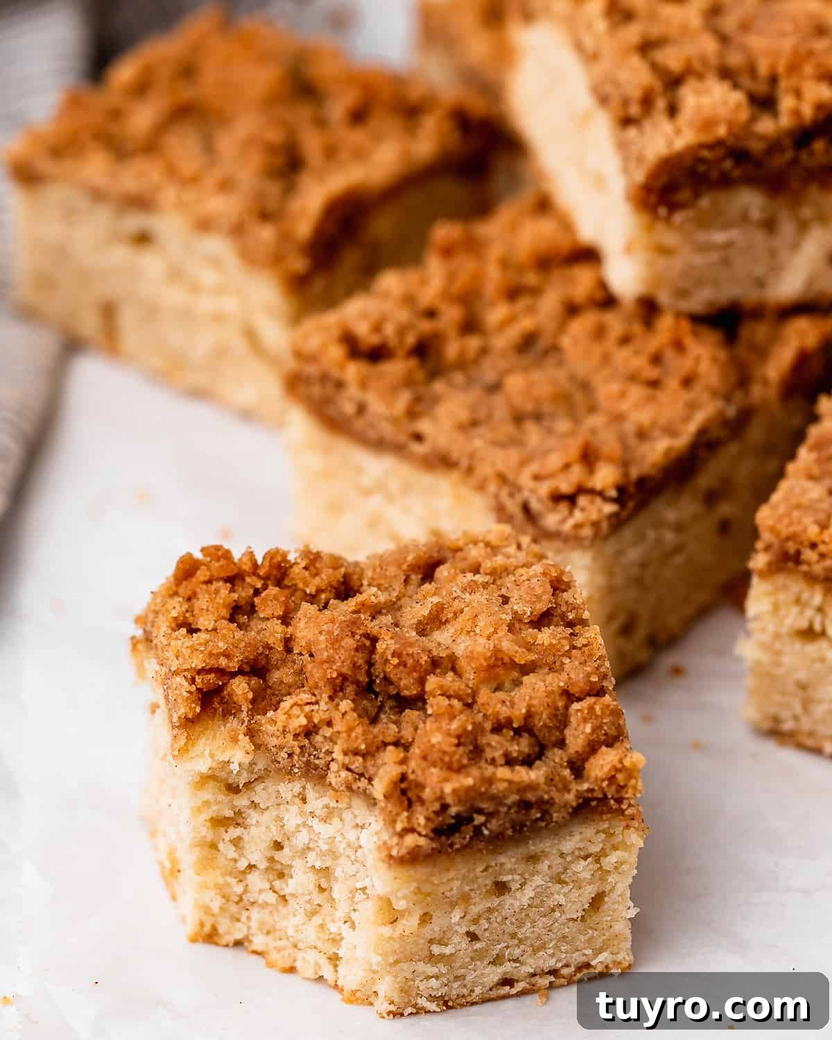5 pieces of Cinnamon Coffee Cake, one with a bite taken out of it