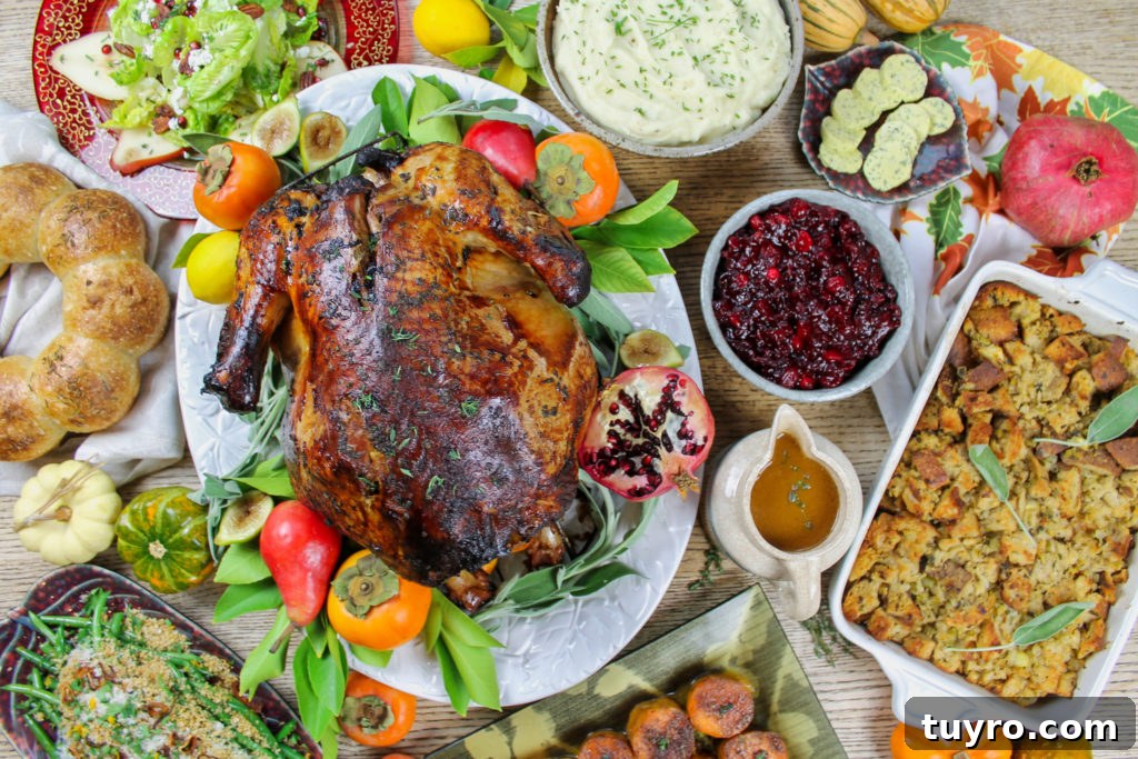 Thanksgiving Table Settings and Centerpiece Ideas 2 thanksgiving dinner table with turkey, gravy, stuffing, cranberry sauce, mashed potatoes