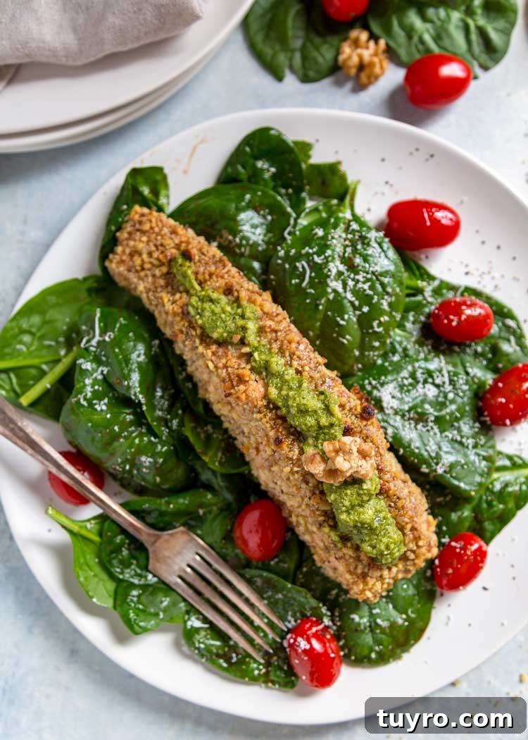 For my Walnut Crusted Pesto Salmon I pressed fresh, chopped California Walnuts on all sides and topped the baked salmon with a homemade walnut pesto instead of the traditional pine nuts. Tender and flakey, this salmon is baked, quick and on the table in under 30 minutes. overhead photo of Walnut Crusted Pesto Salmon