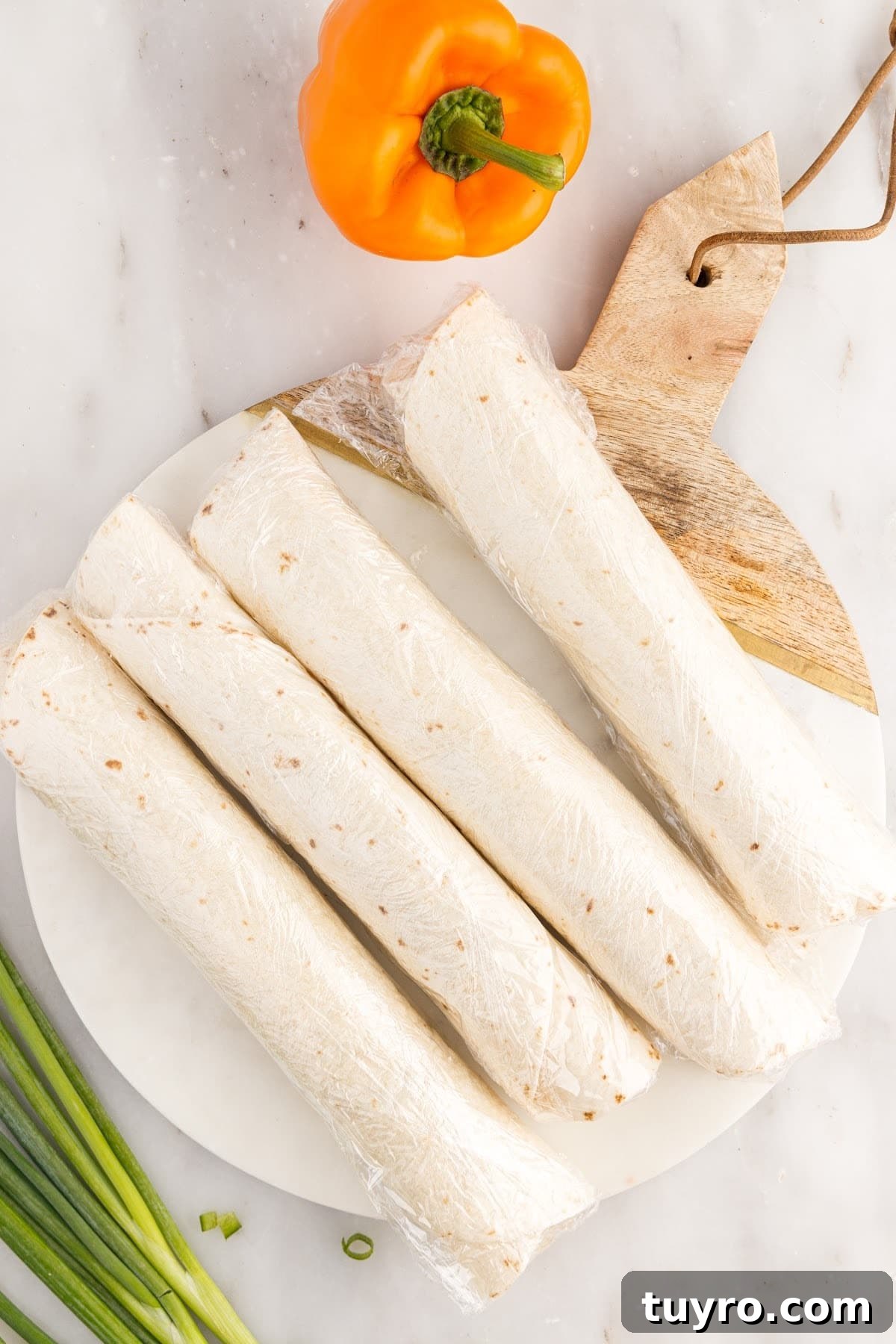 Creamy Ranch Pinwheel Appetizers for Parties and Potlucks 7 Top view of 4 wrapped cream cheese tortilla rollups.