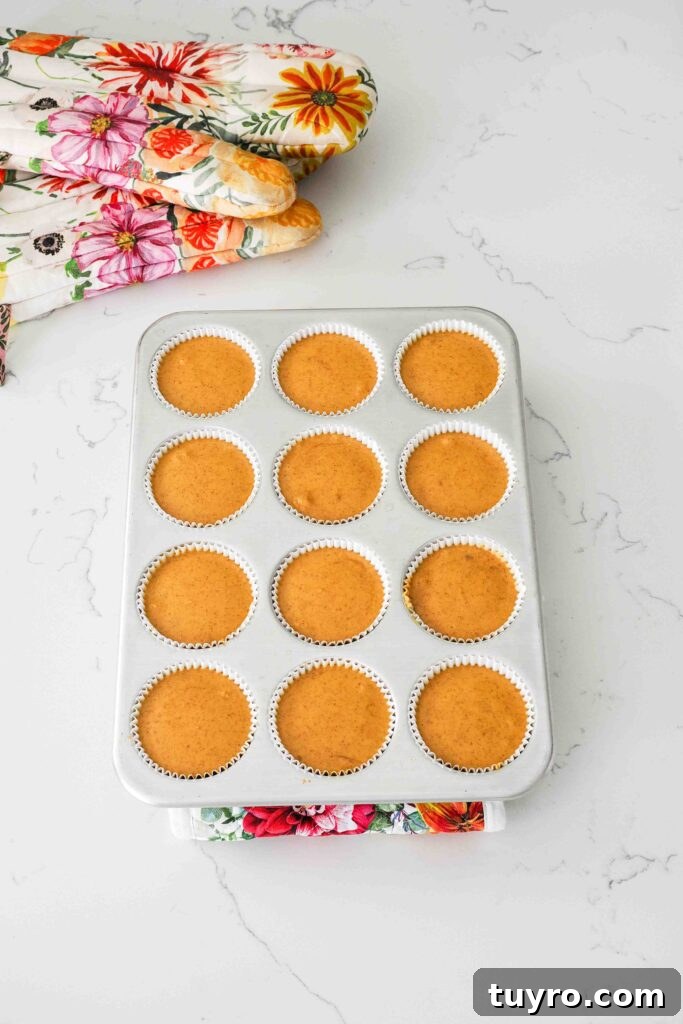 Mini Pumpkin Cheesecake Bites with Spiced Gingersnap Crust 13 Baked mini pumpkin cheesecakes in a muffin pan.