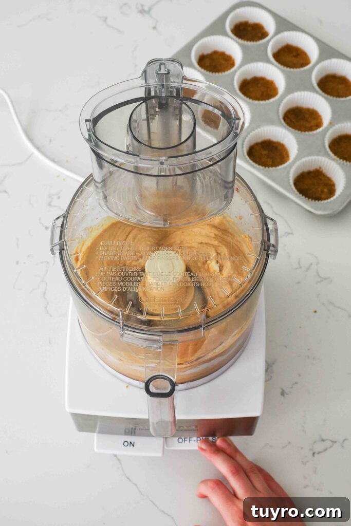 Mini Pumpkin Cheesecake Bites with Spiced Gingersnap Crust 8 Pumpkin cheesecake being processed in a food processor.