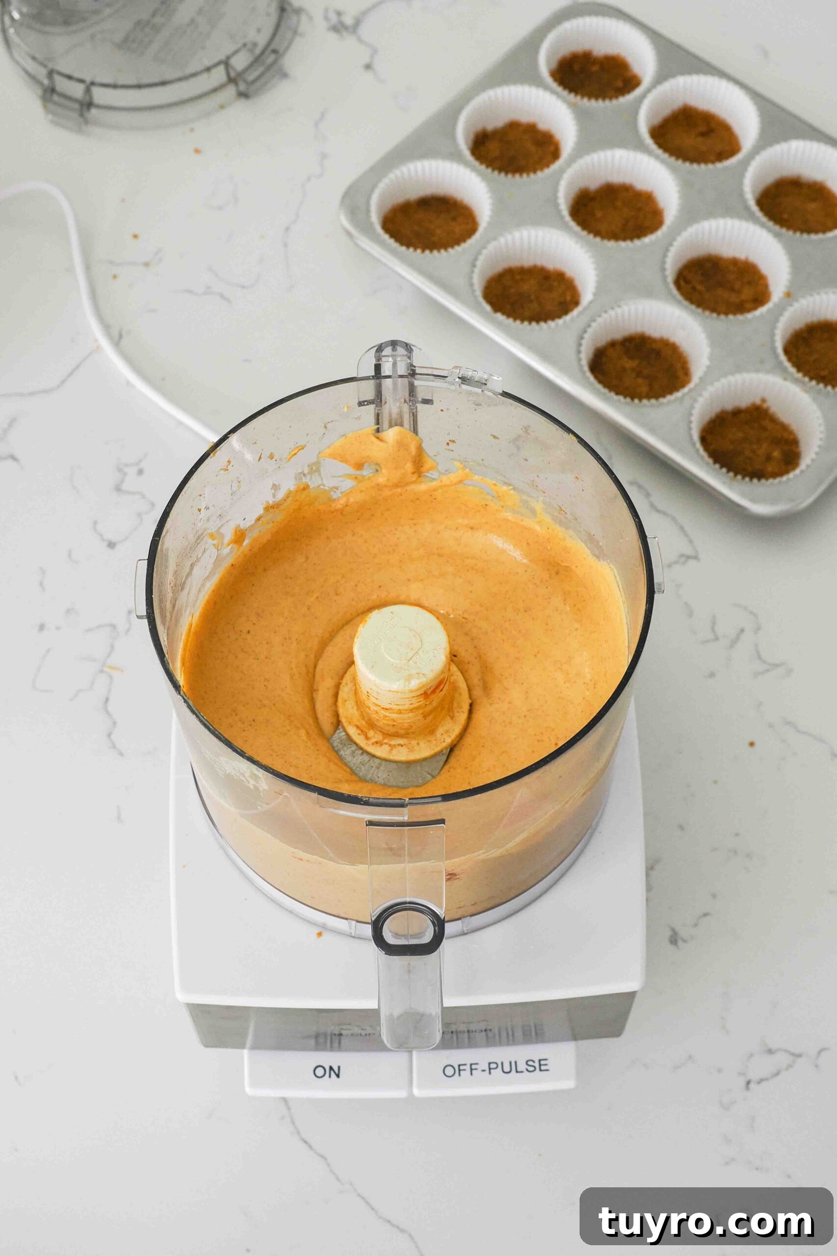 Mini Pumpkin Cheesecake Bites with Spiced Gingersnap Crust 10 Smooth and creamy pumpkin cheesecake filling in a food processor.