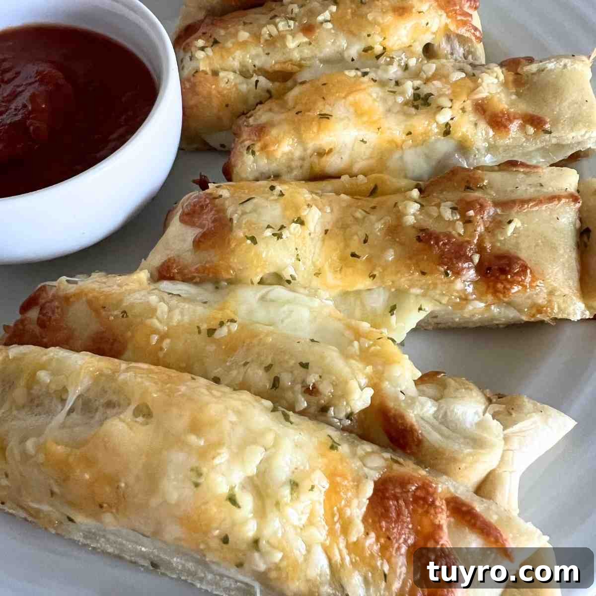 Domino’s Stuffed Cheesy Bread: How to Order, Calories & Ingredients 2 Dominos stuffed cheesy bread cut into slices.