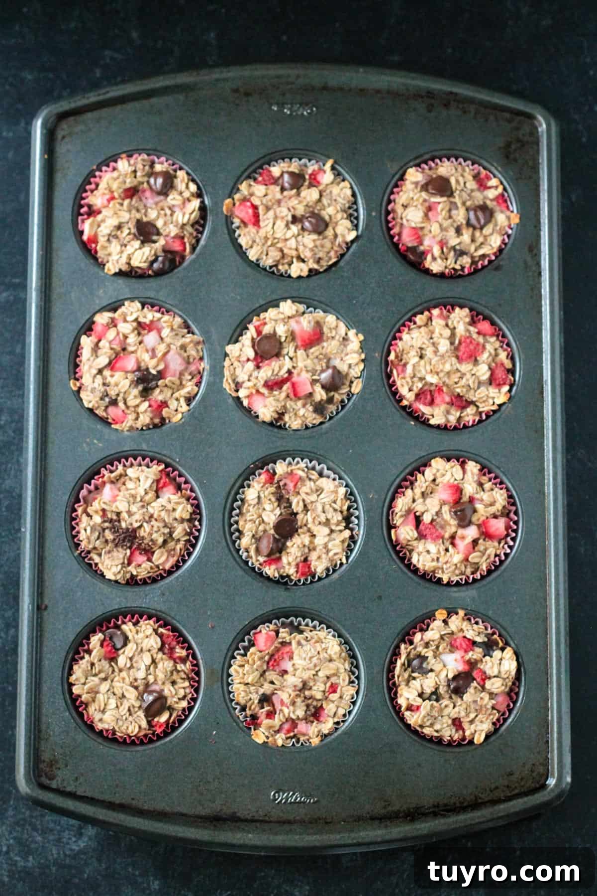 Strawberry Baked Oatmeal Muffins Recipe for Moist Breakfast Bites 7 Baked strawberry oatmeal muffins in the pan.