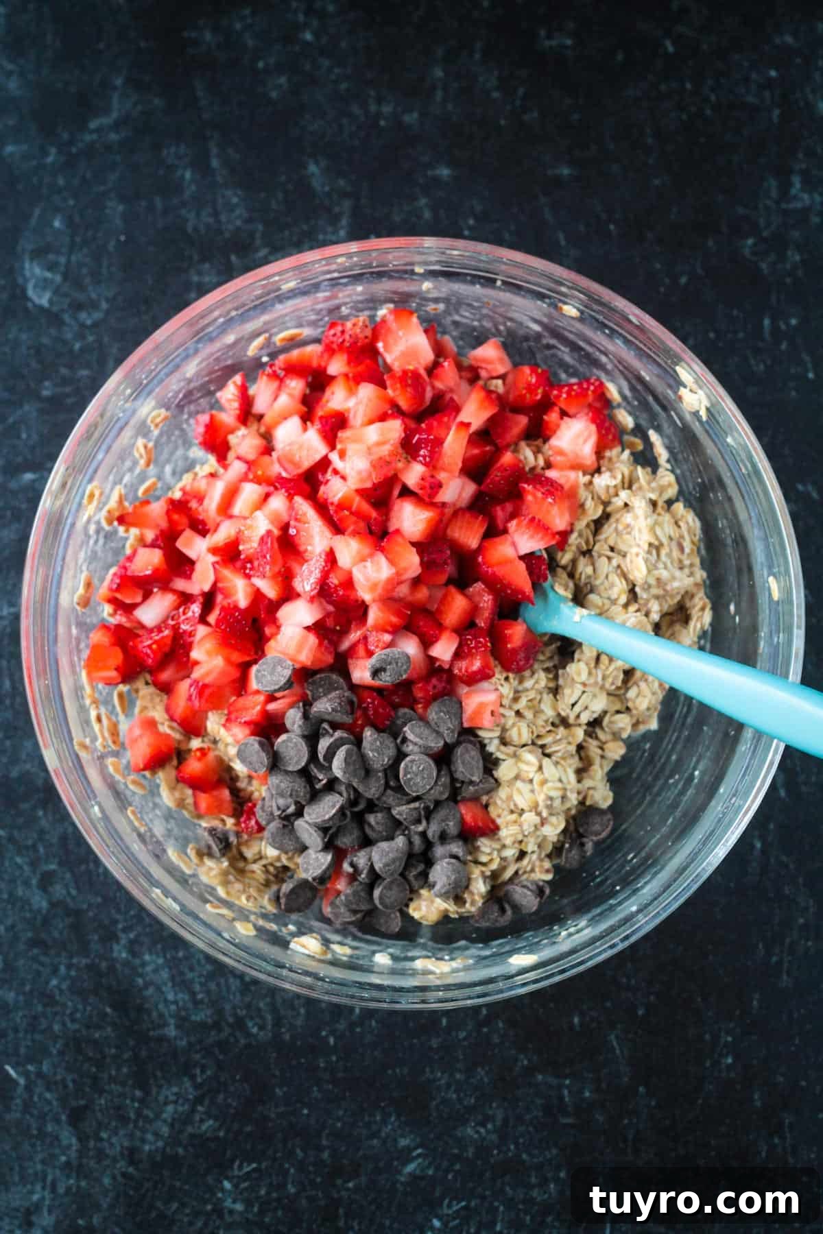 Strawberry Baked Oatmeal Muffins Recipe for Moist Breakfast Bites 5 Diced strawberries and chocolate chips added to the batter.