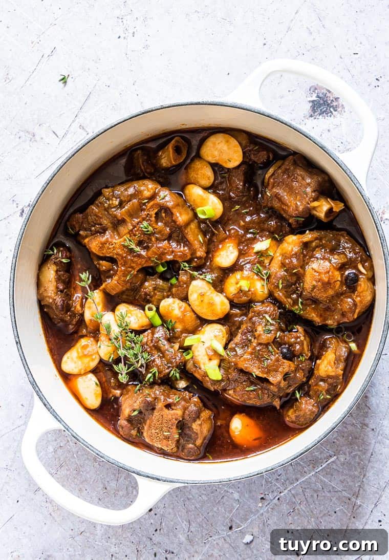 Gluten-Free Jamaican Oxtail Stew Recipe for Rich, Authentic Flavor 4 Jamaican Oxtail Stew served in a white ceramic pot.