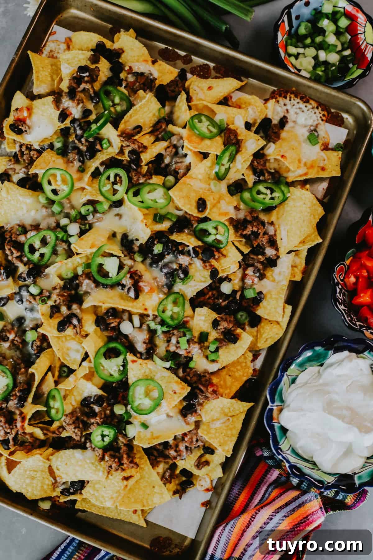 Loaded Oven Baked Beef Nachos with Melted Cheese 2 overhead shot of sheet pan nachos with ground beef and beans.