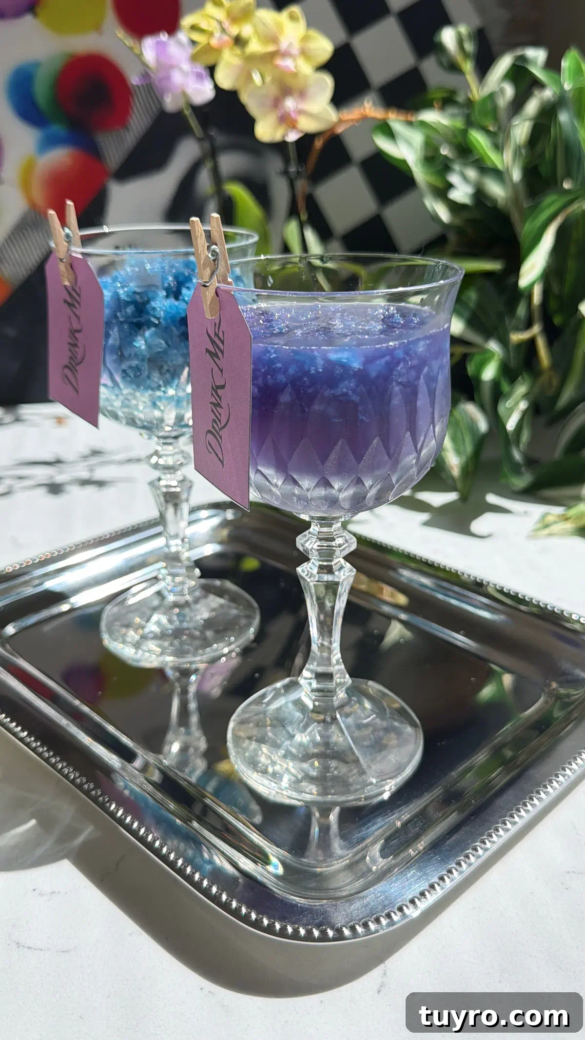 Galaxy Cotton Candy Lemonade Cocktail — Color-Changing Drink Tutorial 4 Two crystal glasses on a silver tray showing the galaxy cocktail color change. One glass contains just the blue butterfly pea granita, and the other shows the vivid purple mixed drink.